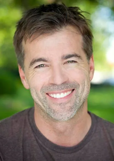 man showing off his new dental implants with a big smile