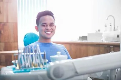 patient smiling after sedation helped him sleep during his dental procedure