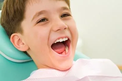 child laughing while visiting Scott Condie Dentistry