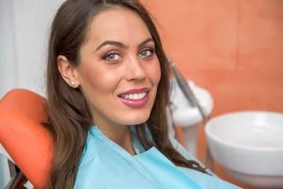 patient smiling after her oral surgery procedure at Scott Condie Dentistry