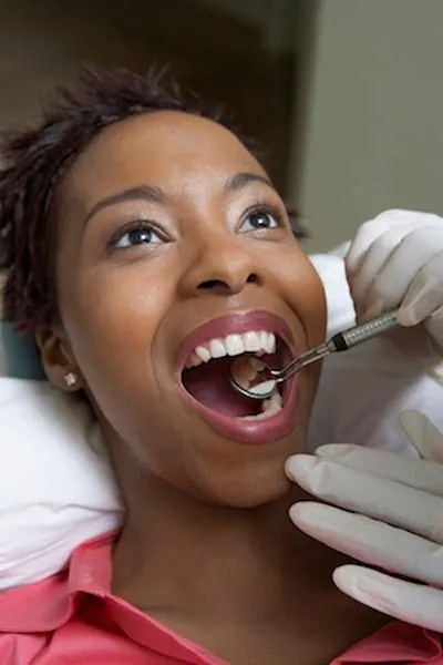 patient getting a checkup after her restorative dentistry procedure